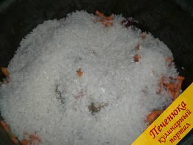 5) Теперь засыпаем сухой (не промываем) длинный рис. Крупу разровнять по поверхности. Залить водой. Посолить.