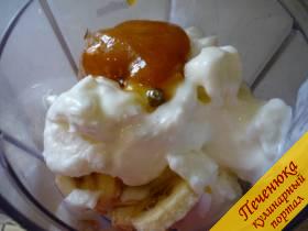 3) В емкость кухонного комбайна выкладываем замороженные кусочки банана и выдавливаем замерзший йогурт. Кладем ложку жидкого меда для сладости. 